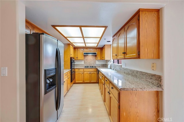 1161 Spazier Ave Unit 4, Glendale, CA 91201 - kitchen with stainless steel fridge with ice dispenser, a sink, black cooktop, under cabinet range hood, and light wood-style flooring