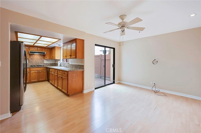 1161 Spazier Ave Unit 4, Glendale, CA 91201 - kitchen with black appliances, a sink, brown cabinets, light wood-style floors, and a ceiling fan