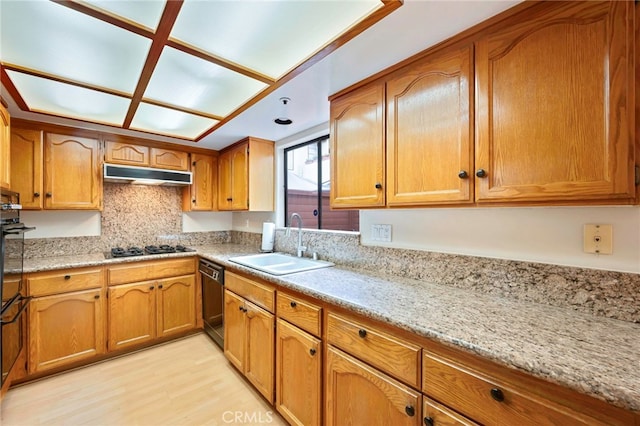 1161 Spazier Ave Unit 4, Glendale, CA 91201 - kitchen with a sink, under cabinet range hood, black appliances, light wood finished floors, and brown cabinets