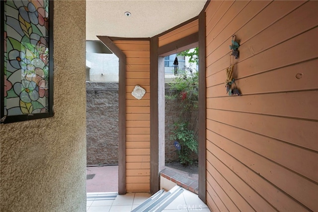 1161 Spazier Ave Unit 4, Glendale, CA 91201 - doorway to outside with wooden walls, tile patterned floors, and a textured ceiling