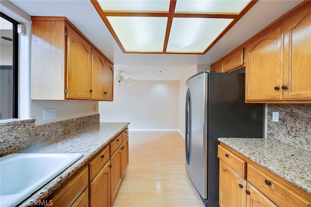 1161 Spazier Ave Unit 4, Glendale, CA 91201 - kitchen with freestanding refrigerator, light wood-type flooring, a sink, decorative backsplash, and light stone countertops