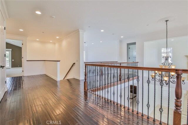 12932 Carnesi Dr, Rancho Cucamonga, CA 91739 - corridor with wood finished floors, a chandelier, baseboards, an upstairs landing, and crown molding