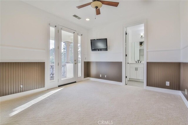 12932 Carnesi Dr, Rancho Cucamonga, CA 91739 - unfurnished living room featuring ceiling fan, carpet flooring, a wainscoted wall, and a sink