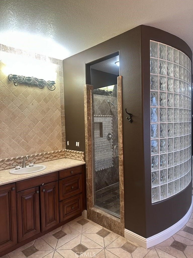 12932 Carnesi Dr, Rancho Cucamonga, CA 91739 - bathroom with a stall shower, vanity, tile patterned floors, and a textured ceiling