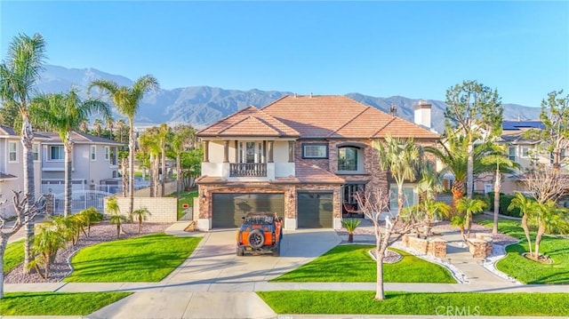 12932 Carnesi Dr, Rancho Cucamonga, CA 91739 - view of front of home with a balcony, a mountain view, an attached garage, driveway, and stucco siding