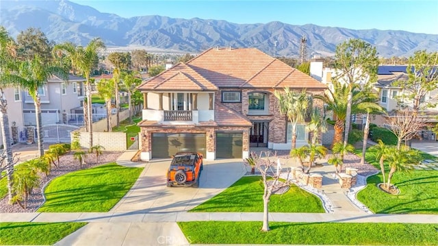 12932 Carnesi Dr, Rancho Cucamonga, CA 91739 - view of front facade featuring a garage, stucco siding, driveway, a balcony, and a mountain view
