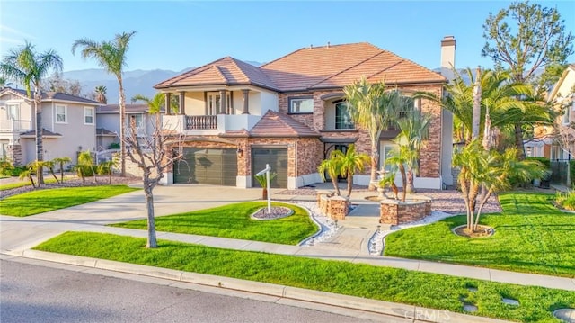 12932 Carnesi Dr, Rancho Cucamonga, CA 91739 - view of front of property featuring an attached garage, concrete driveway, a mountain view, and a front lawn