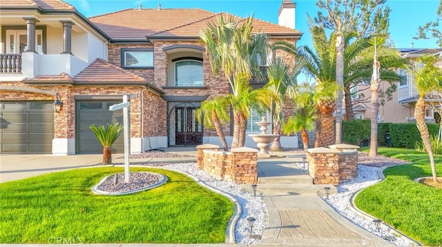 12932 Carnesi Dr, Rancho Cucamonga, CA 91739 - mediterranean / spanish home with a tile roof, a garage, driveway, a chimney, and stucco siding