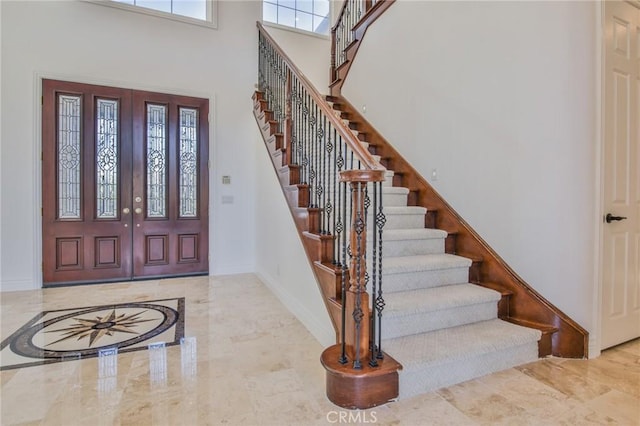 12932 Carnesi Dr, Rancho Cucamonga, CA 91739 - foyer featuring marble tiled floors, stairway, a high ceiling, and baseboards