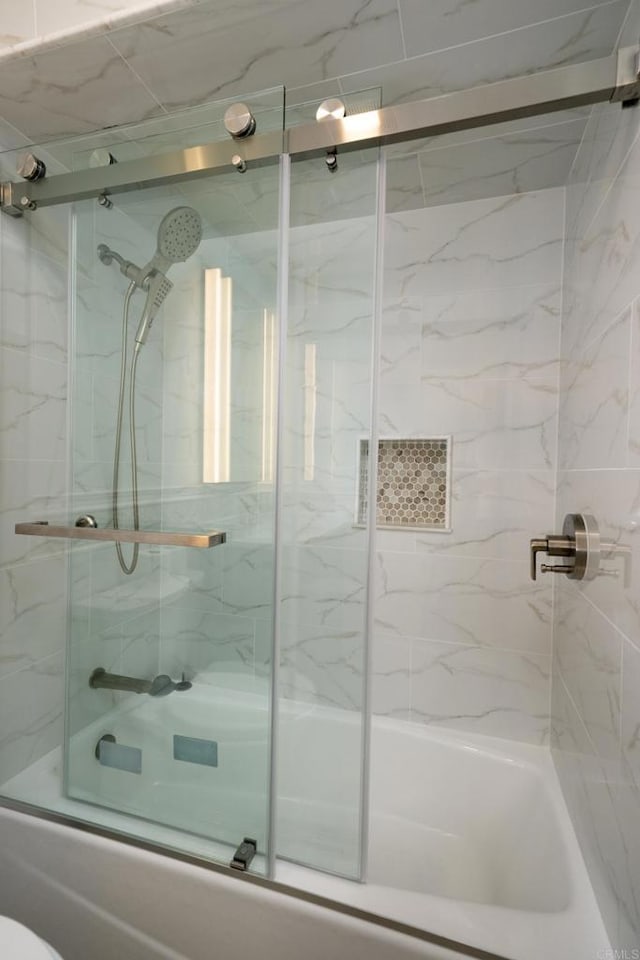 full bath with bath / shower combo with glass door