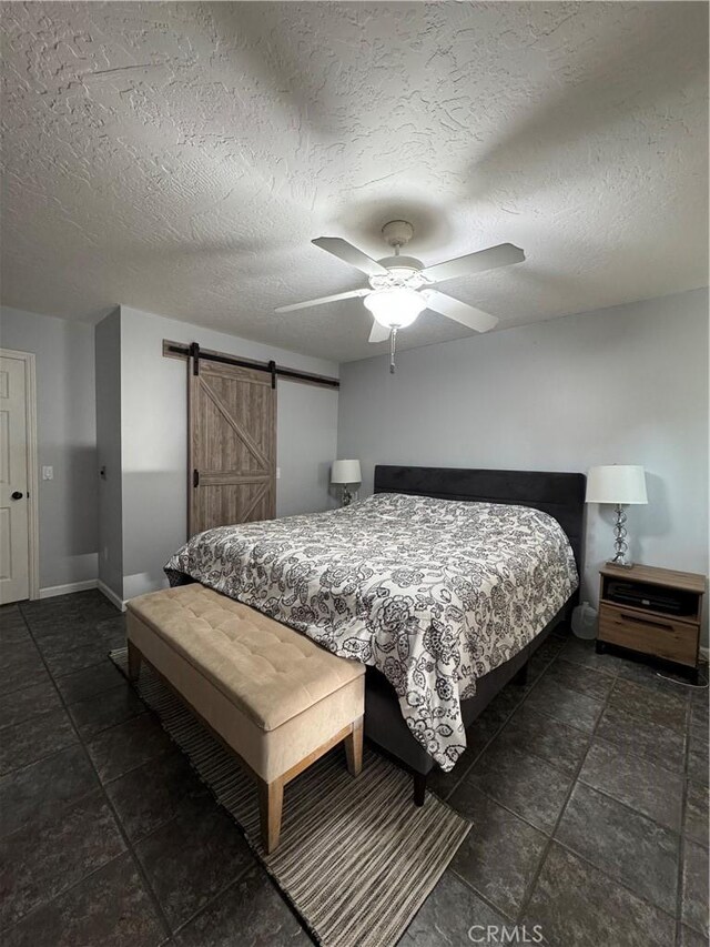 3542 Ponderosa Dr, Oceanside, CA 92058 - bedroom featuring a barn door, baseboards, a ceiling fan, and a textured ceiling
