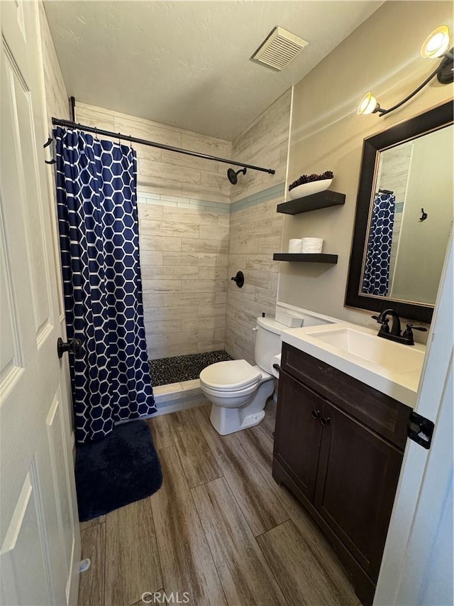 3542 Ponderosa Dr, Oceanside, CA 92058 - full bath featuring wood finished floors, tiled shower, toilet, and vanity