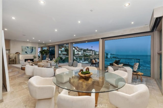 1907 Ocean Way, Laguna Beach, CA 92651 - dining space featuring a warm lit fireplace, recessed lighting, and floor to ceiling windows