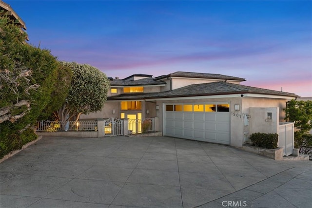 1907 Ocean Way, Laguna Beach, CA 92651 - prairie-style home with stucco siding, a garage, driveway, fence, and a gate