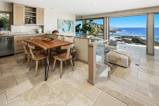 1907 Ocean Way, Laguna Beach, CA 92651 - dining space with beverage cooler, stone tile floors, a water view, recessed lighting, and plenty of natural light