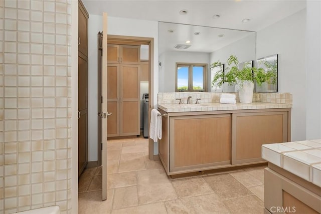 1907 Ocean Way, Laguna Beach, CA 92651 - full bath featuring washer / dryer, vanity, stone tile floors, and recessed lighting