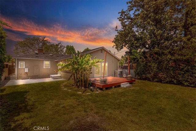 1924 N Evergreen St, Burbank, CA 91505 - back of house at dusk with a yard, stucco siding, and a deck