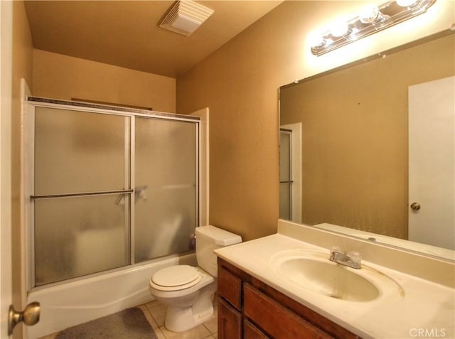 full bathroom featuring tile patterned floors, toilet, vanity, and enclosed tub / shower combo