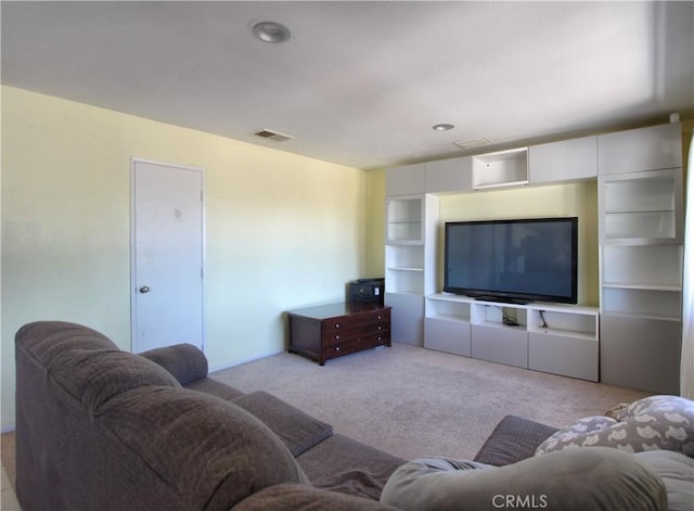 carpeted living room featuring built in shelves