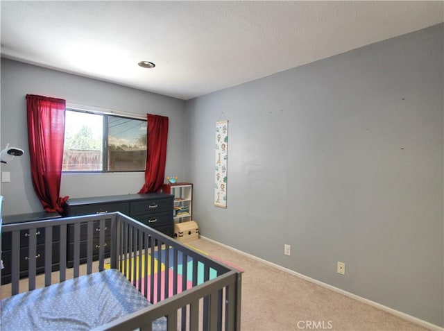 carpeted bedroom with baseboards