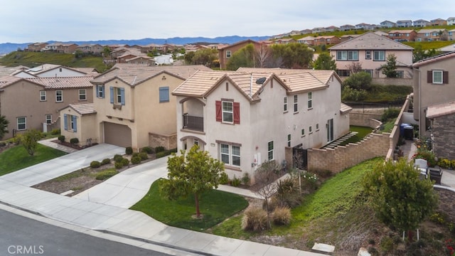 29048 N W Hills Dr, Valencia, CA 91354 - view of front facade featuring a residential view, a garage, concrete driveway, stucco siding, and a tile roof