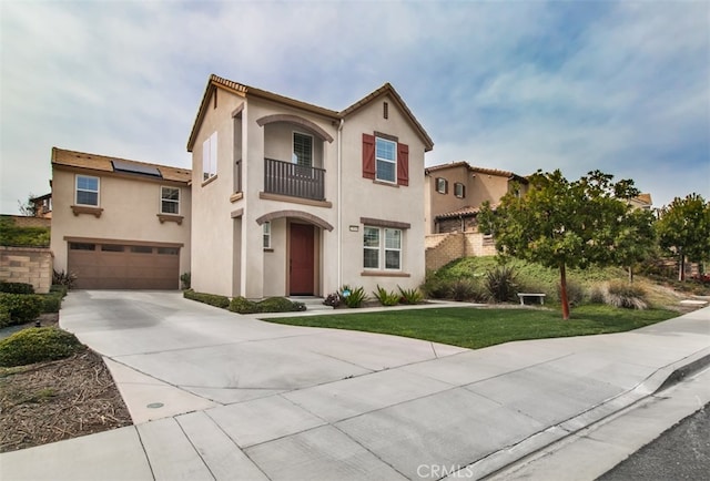 29048 N W Hills Dr, Valencia, CA 91354 - mediterranean / spanish home with a balcony, an attached garage, stucco siding, concrete driveway, and roof mounted solar panels