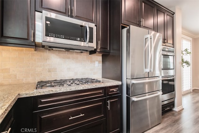 29048 N W Hills Dr, Valencia, CA 91354 - kitchen with stainless steel appliances, decorative backsplash, wood finished floors, light stone counters, and ornamental molding