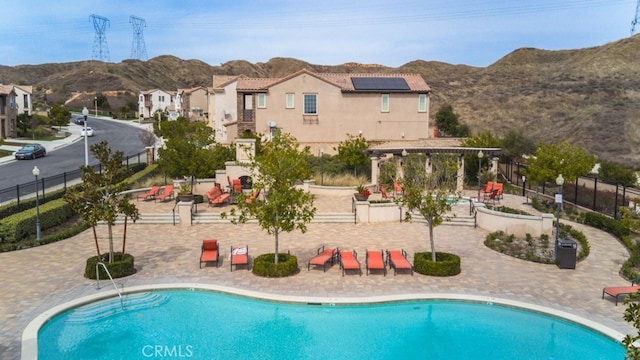 29048 N W Hills Dr, Valencia, CA 91354 - community pool with a mountain view, a pergola, and a patio
