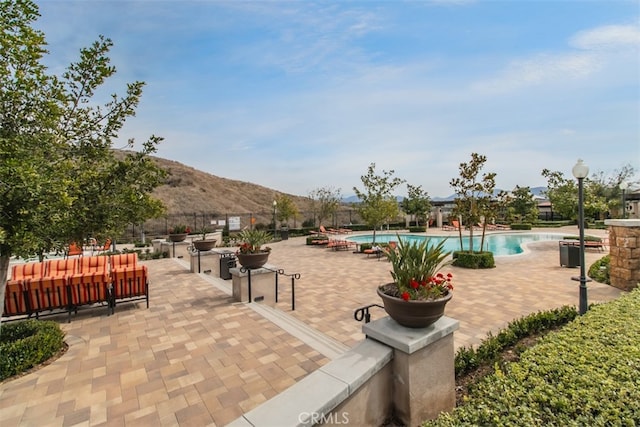 29048 N W Hills Dr, Valencia, CA 91354 - view of home's community featuring a mountain view, a pool, and a patio area