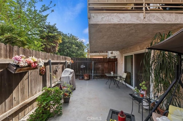 view of patio featuring fence
