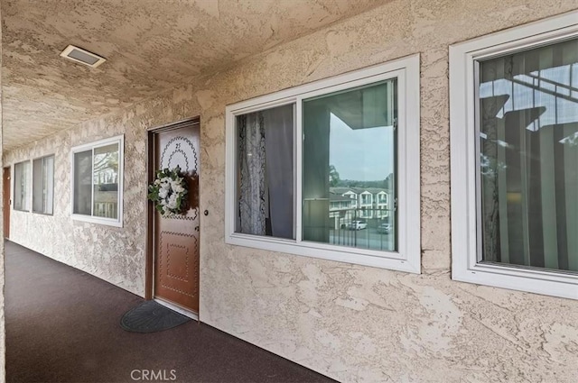 property entrance featuring stucco siding