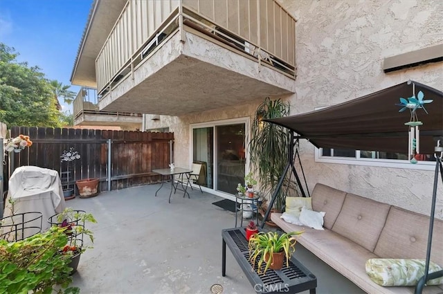 view of patio / terrace featuring an outdoor living space and fence