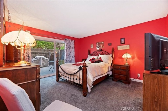 carpeted bedroom with access to exterior and baseboards