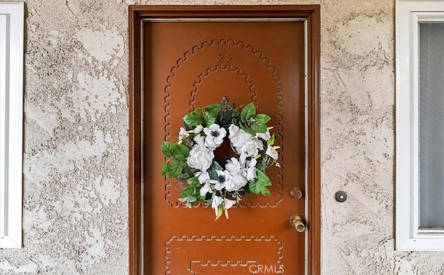 doorway to property with stucco siding