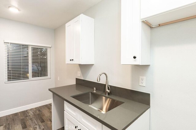 4401 La Clede Ave, Los Angeles, CA 90039 - kitchen with a sink, dark countertops, dark wood finished floors, white cabinetry, and baseboards