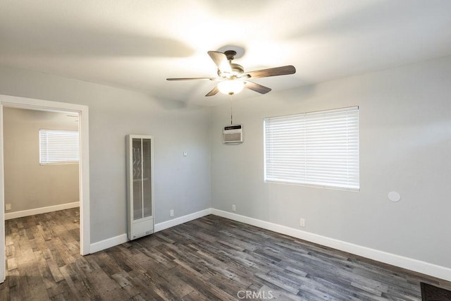 4401 La Clede Ave, Los Angeles, CA 90039 - spare room featuring a heating unit, a ceiling fan, dark wood-type flooring, baseboards, and a wall mounted air conditioner