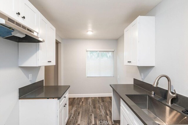 4401 La Clede Ave, Los Angeles, CA 90039 - kitchen with a sink, under cabinet range hood, dark wood-style flooring, and white cabinets