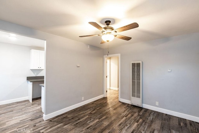 4401 La Clede Ave, Los Angeles, CA 90039 - spare room featuring a heating unit, a ceiling fan, dark wood-style flooring, and baseboards