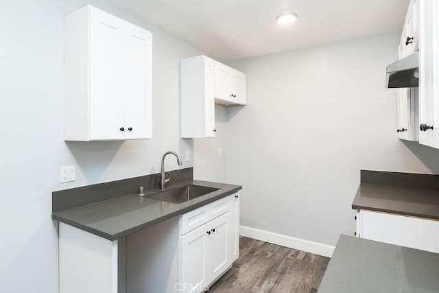 4401 La Clede Ave, Los Angeles, CA 90039 - kitchen with a sink, under cabinet range hood, dark countertops, dark wood-style floors, and white cabinets
