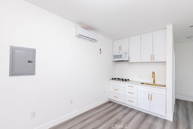 4401 La Clede Ave, Los Angeles, CA 90039 - kitchen featuring white microwave, electric panel, a wall mounted AC, a sink, and light wood finished floors