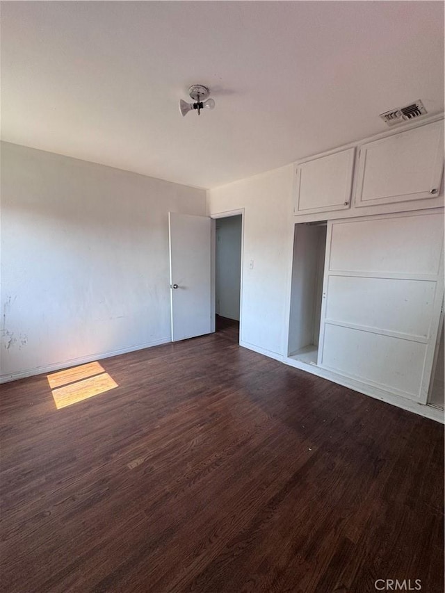 15407 S Visalia Ave, Compton, CA 90220 - unfurnished bedroom featuring dark wood-style flooring and baseboards