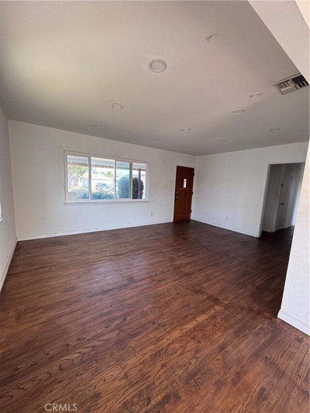 15407 S Visalia Ave, Compton, CA 90220 - unfurnished room with dark wood-style floors and baseboards