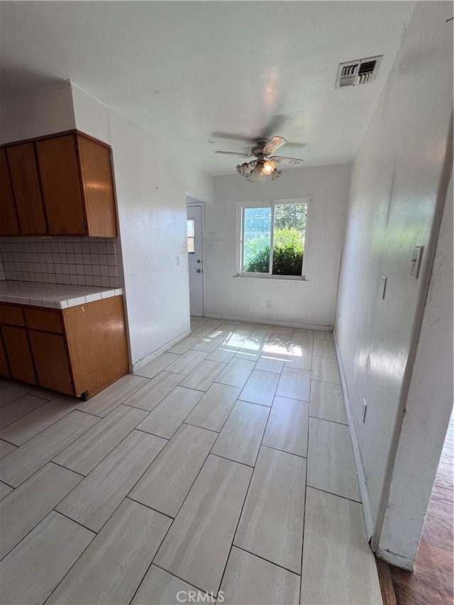 15407 S Visalia Ave, Compton, CA 90220 - unfurnished living room featuring ceiling fan, wood tiled floors, and baseboards