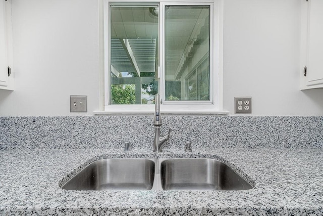 43451 Briercliff Dr, Hemet, CA 92544 - kitchen view of a sink, white cabinetry, and light stone counters