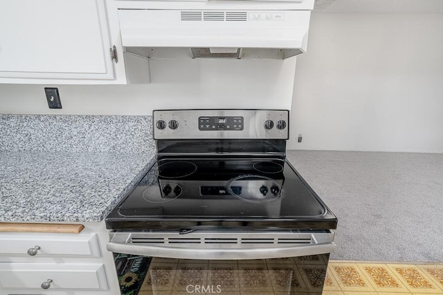 43451 Briercliff Dr, Hemet, CA 92544 - kitchen featuring stainless steel range with electric stovetop, under cabinet range hood, white cabinetry, carpet, and light countertops
