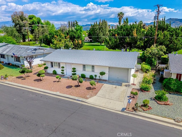 43451 Briercliff Dr, Hemet, CA 92544 - single story home featuring driveway, roof with shingles, a garage, and a mountain view