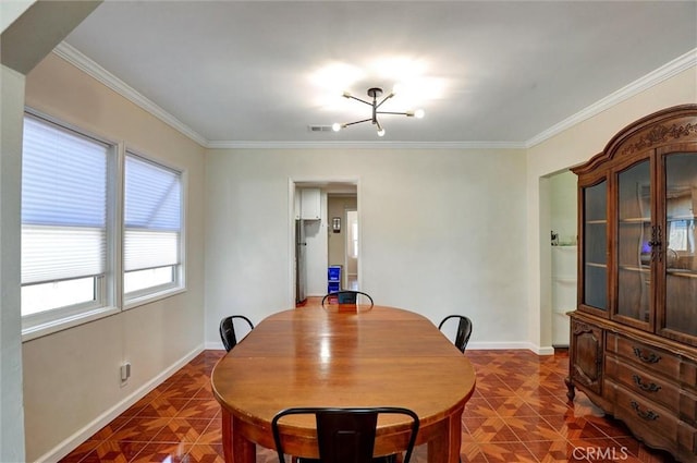5864 Bonsallo Ave, Los Angeles, CA 90044 - dining space with dark tile patterned floors, ornamental molding, a chandelier, and baseboards