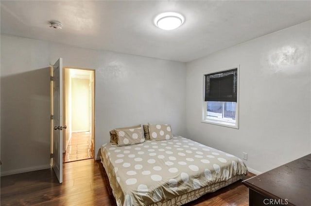 5864 Bonsallo Ave, Los Angeles, CA 90044 - bedroom featuring dark wood-type flooring and baseboards