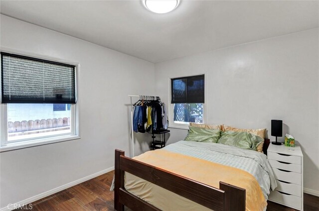 5864 Bonsallo Ave, Los Angeles, CA 90044 - bedroom with multiple windows, wood finished floors, and baseboards