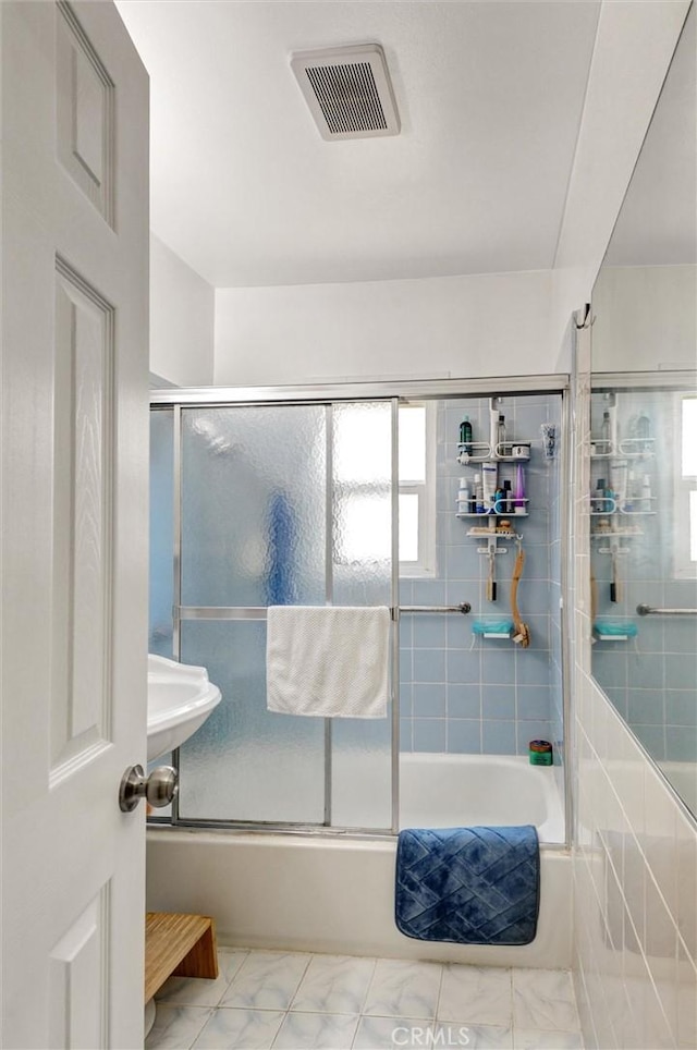 5864 Bonsallo Ave, Los Angeles, CA 90044 - bathroom with combined bath / shower with glass door and marble finish flooring